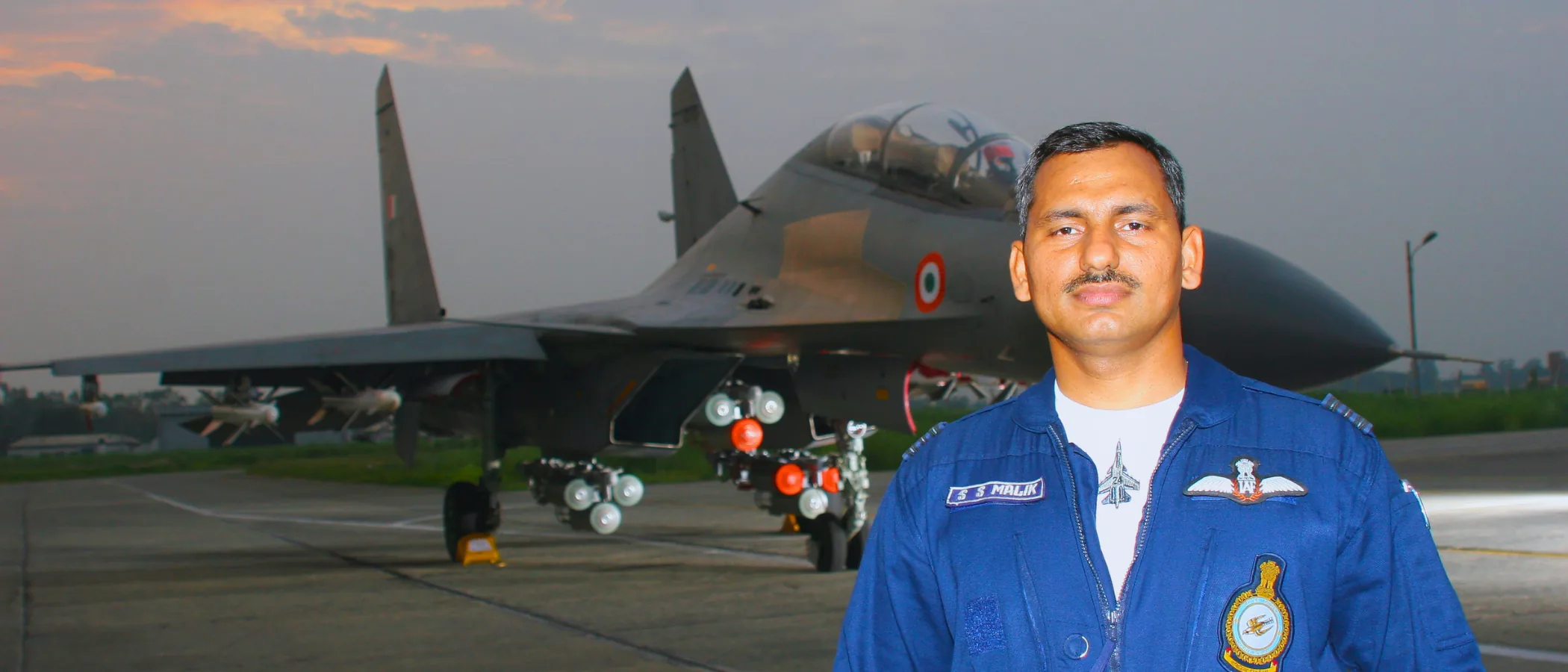 Dr Malik in IAF flight suit in front of a Su-30 MKI